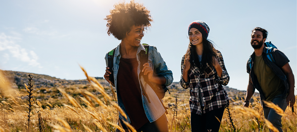 three people on a hike enjoying fresh air and tallgrass meadows, LGBTQIA2S+, access to nature, connecting with nature, the great outdoors, human rights