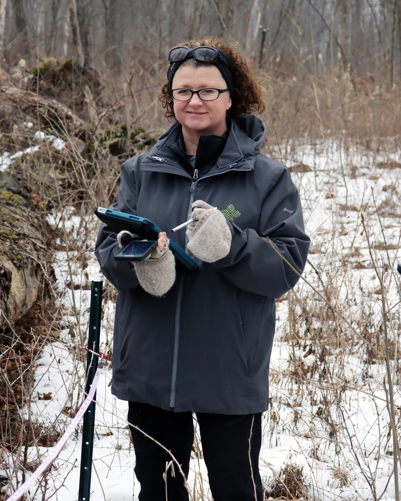 Environmental Educator Eileen Davis records data. Photo © Lake County Forest Preserves.